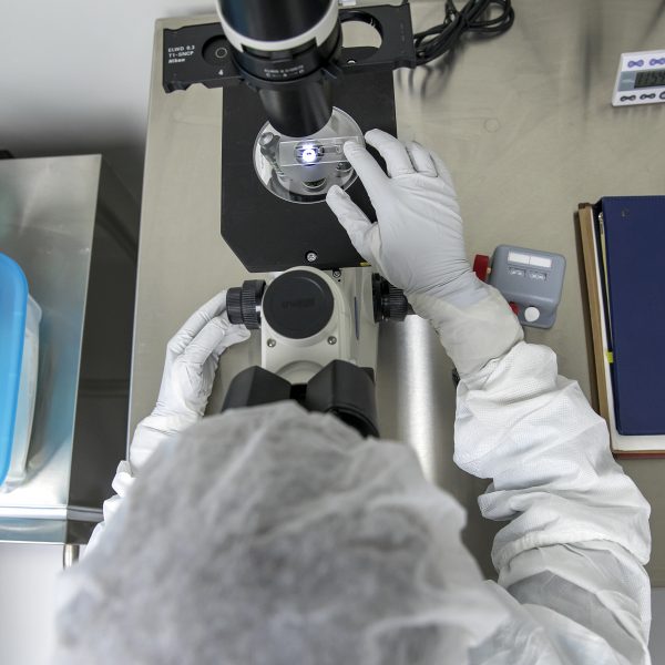 Person using a microscope in a lab