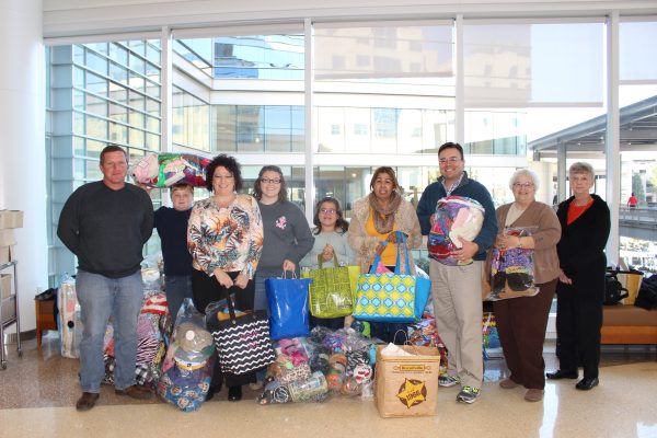 Elizabeth Stewart (third from left) and her family and friends delivered over 2,700 hats, scarves and blankets to the N.C. Cancer Hospital