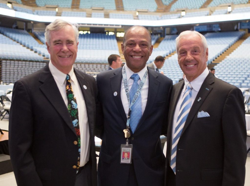 Thomas Shea, Judge Carl Fox and Roy Williams on the floor of the Dean Dome.