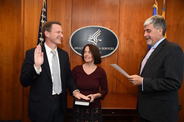 Norman E. Sharpless, MD, accompanied by his wife, Julie Sharpless, MD, is sworn in as NCI director by Acting Secretary of Health and Human Services Eric D. Hargan.