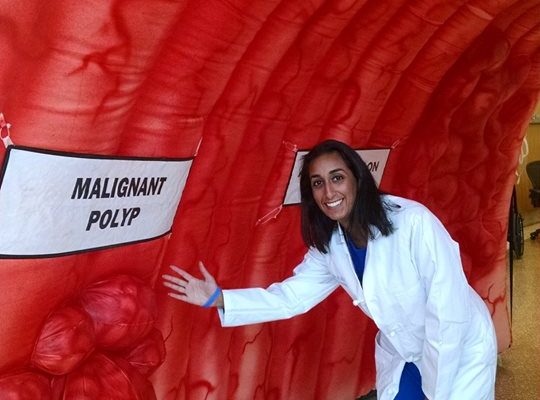 Dr. Sarina Pasricha, a gastroenterology fellow at UNC, inside the Strollin' Colon exhibit set up in the NC Cancer Hospital