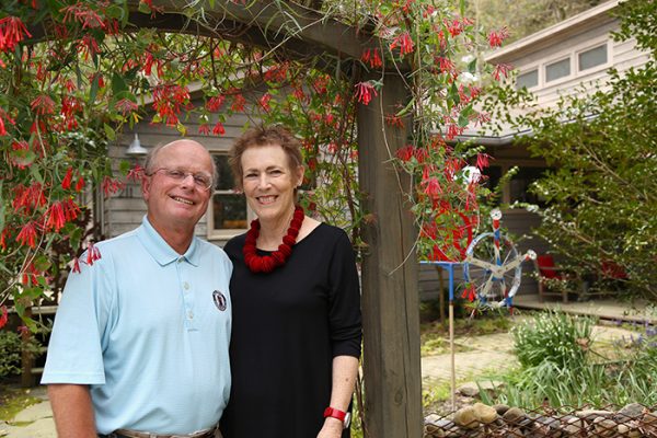 Ralph and Nancy Raasch in the front yard of their home in Carrboro. Nancy views her seventeen-year cancer journey as an opportunity that has allowed her to meet people she wouldn't have met and gain perspectives she otherwise wouldn't have. Ralph, a retir