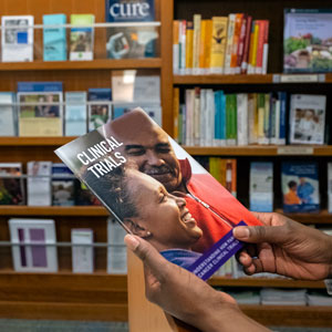 A person reading an informational booklet in the resource library.