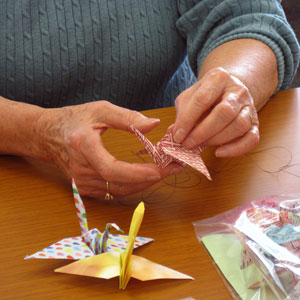 A person making origami cranes.