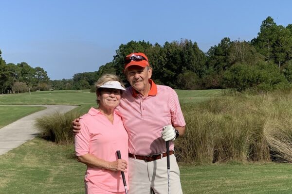 Barry Wetzel with his wife Susan on a golf course.