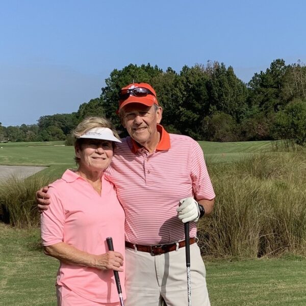 Barry Wetzel with his wife Susan on a golf course.