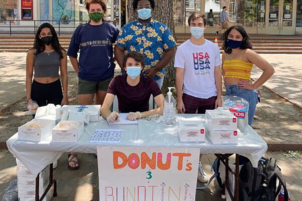 Students at a table selling baked goods for a fundraiser