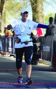 Jackie Alston at the finish line of a 5K race