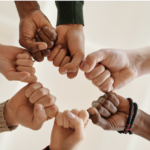 a circle of closed fists supporting each other