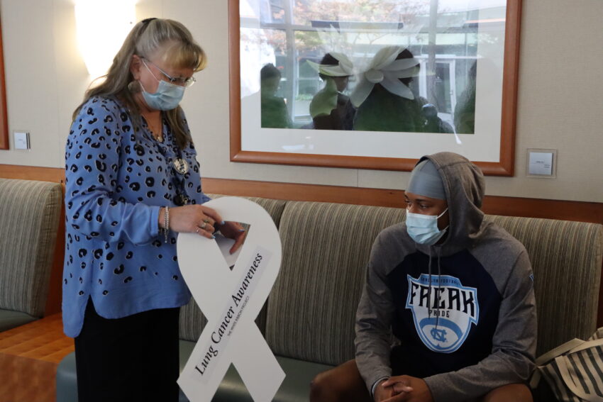 Tammy Allred giving Tylee Craft a white ribbon at the kickoff event