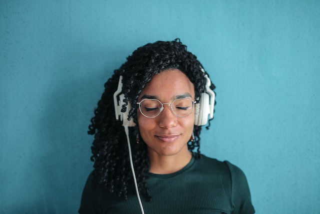 Person with closed eyes listening to headphones