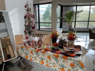 Table with handmade crafts, including Christmas and Thanksgiving holiday decor.