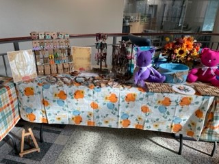 Table with handmade crafts, including jewelry.
